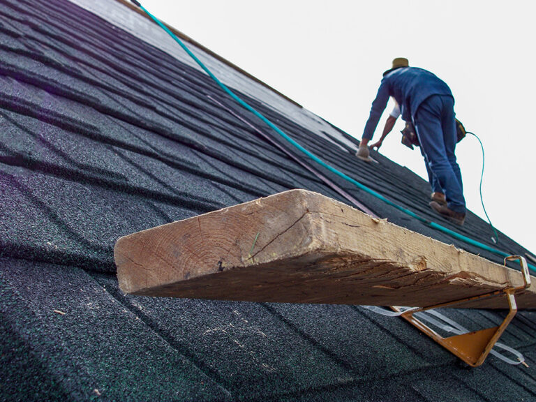 A roofer installing roof bracket