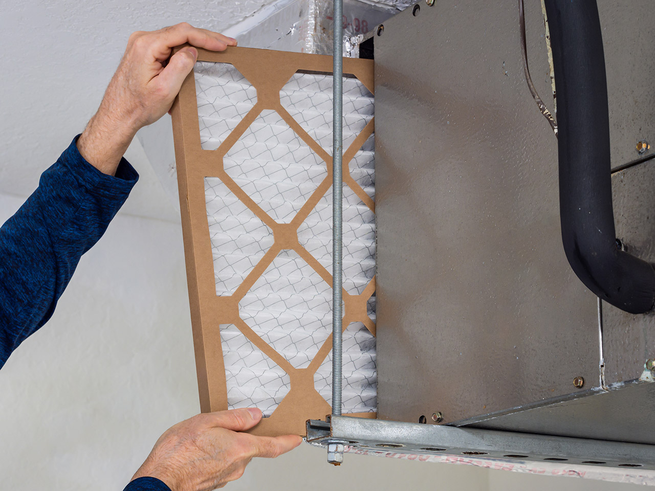 HVAC technician changing dirty air filter