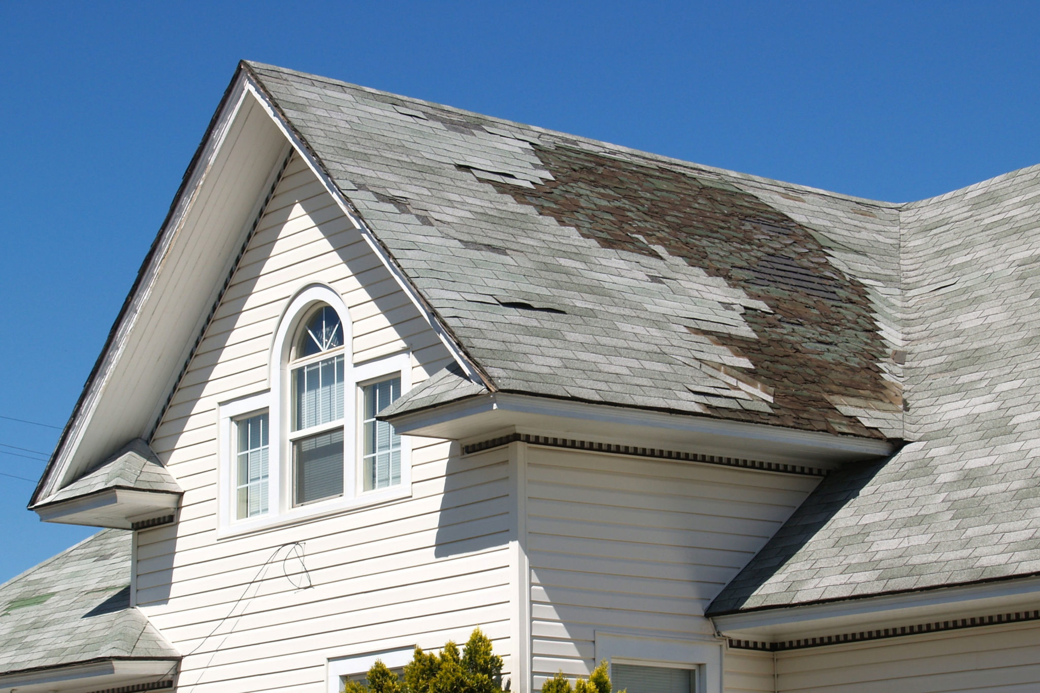 damaged roof with missing shingles