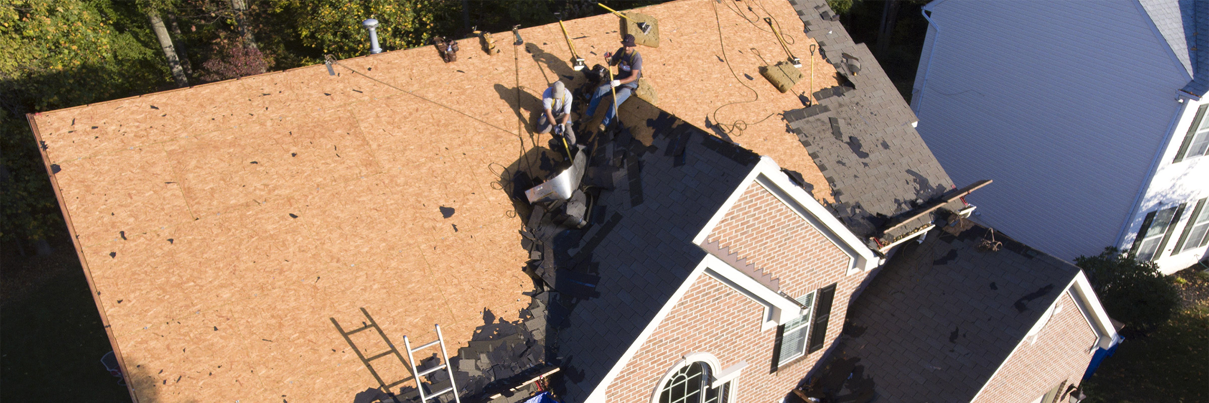 overhead view of roof being stripped before re-shingling