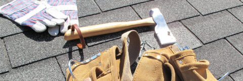 roofing tools on a shingle roof