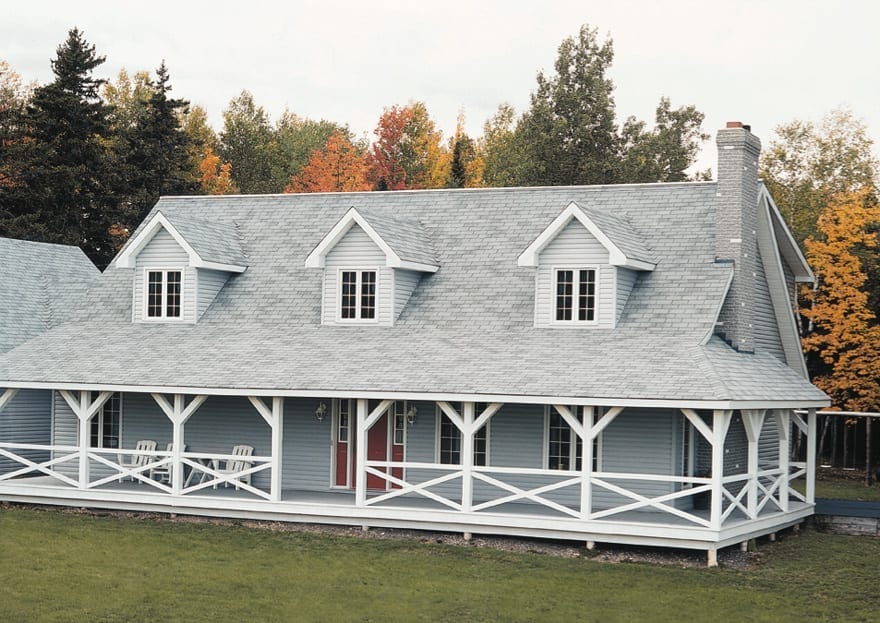 house with a grey 3-tab roof with three dormers