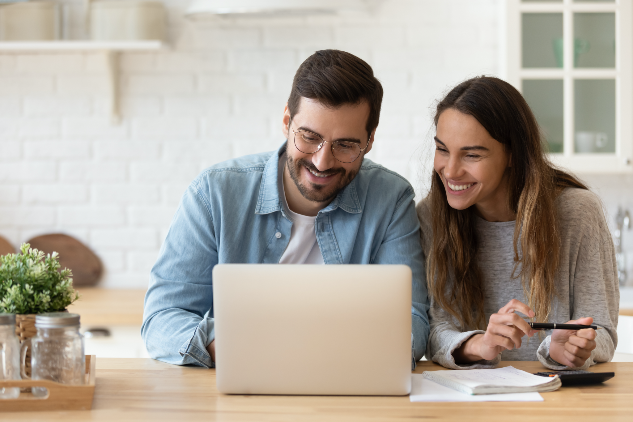 couple planning budget on laptop