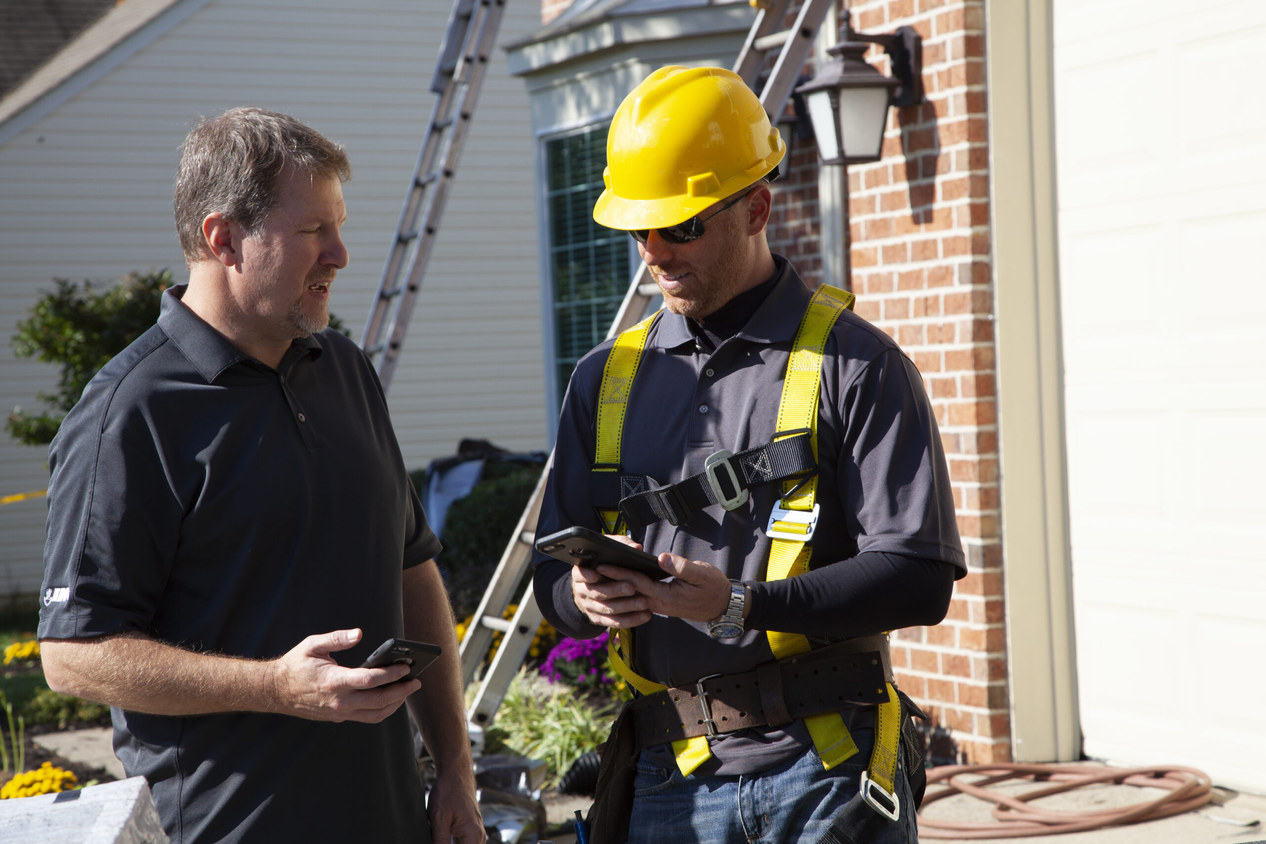 IKO employee talking to a roofer