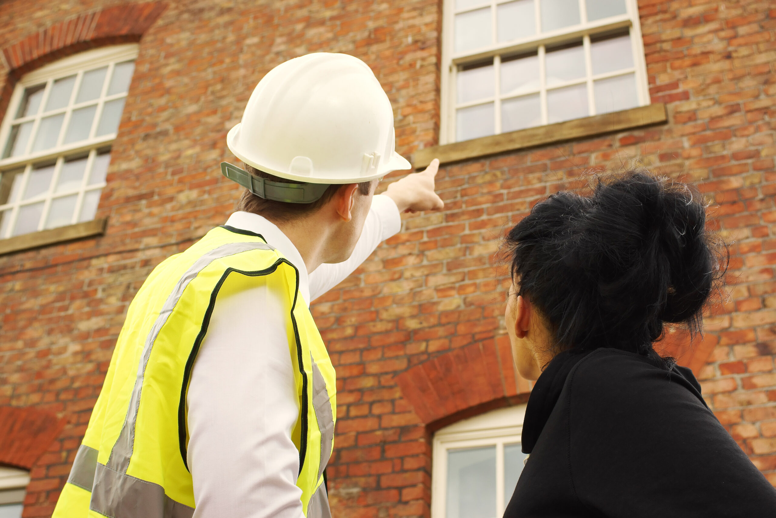 Builder and homeowner looking at a property