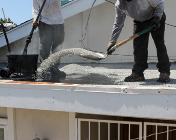 roofer covering roof with gravel