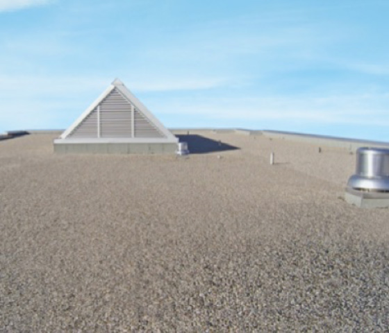 large commercial flat roof coverred by gravel