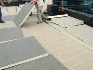 commercial roofers installing Polyiso Rigid Foam insulation on flat roof