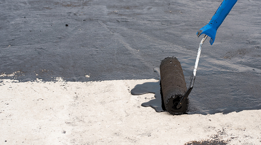 Priming the surface of a roof with a roller