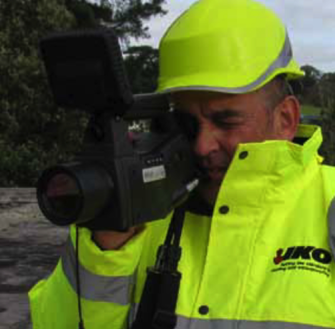 Man holding a Thermographic Camera on a roof