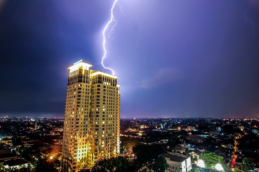 lightning striking the roof of a high rise building