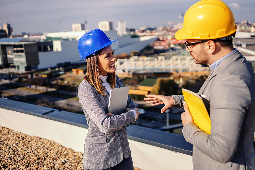 Two roofers discussing about commercial roofing