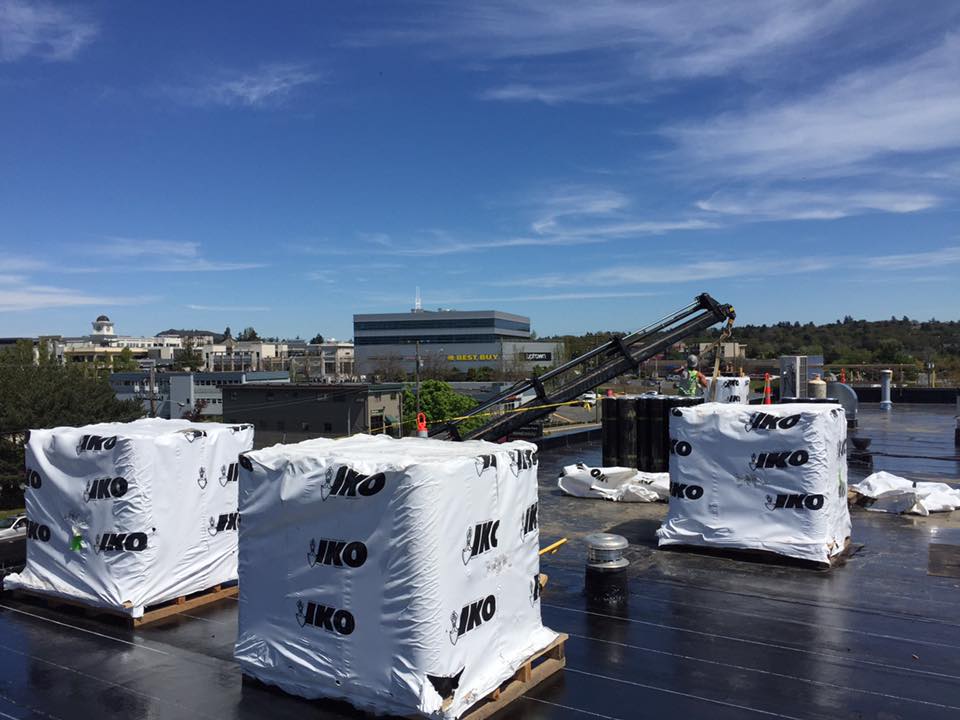 IKO commercial membrane skids loaded onto flat roof