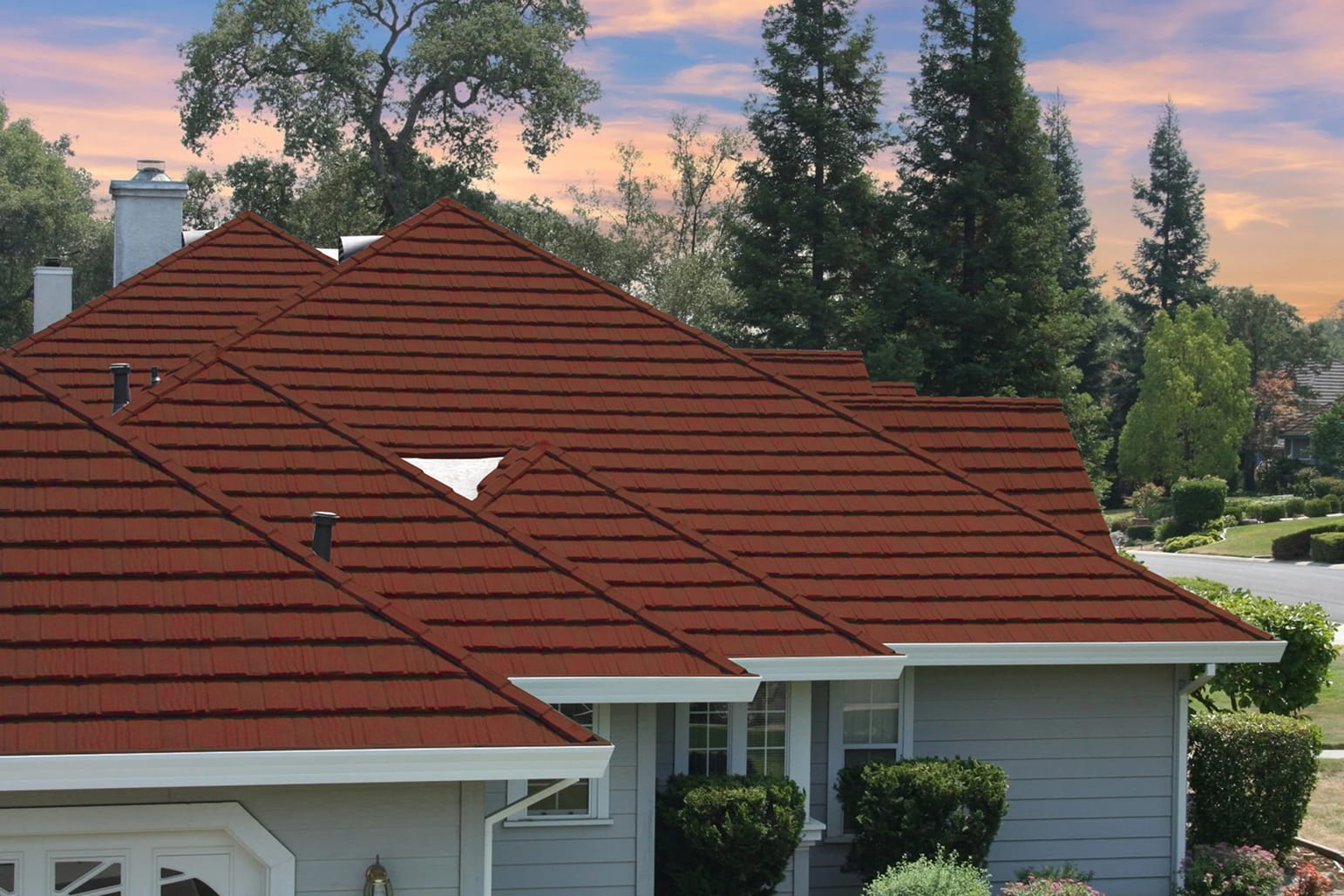 DECRA Farmhouse Shake Heritage Clay stone-coated steel roof on a suburban home with textured clay-red shake tiles