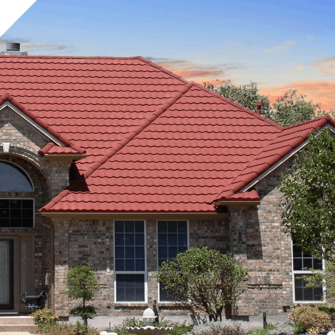 DECRA Tile red Mediterranean-style metal roof on a brick home with arched entry and landscaped front yard, premium tile look