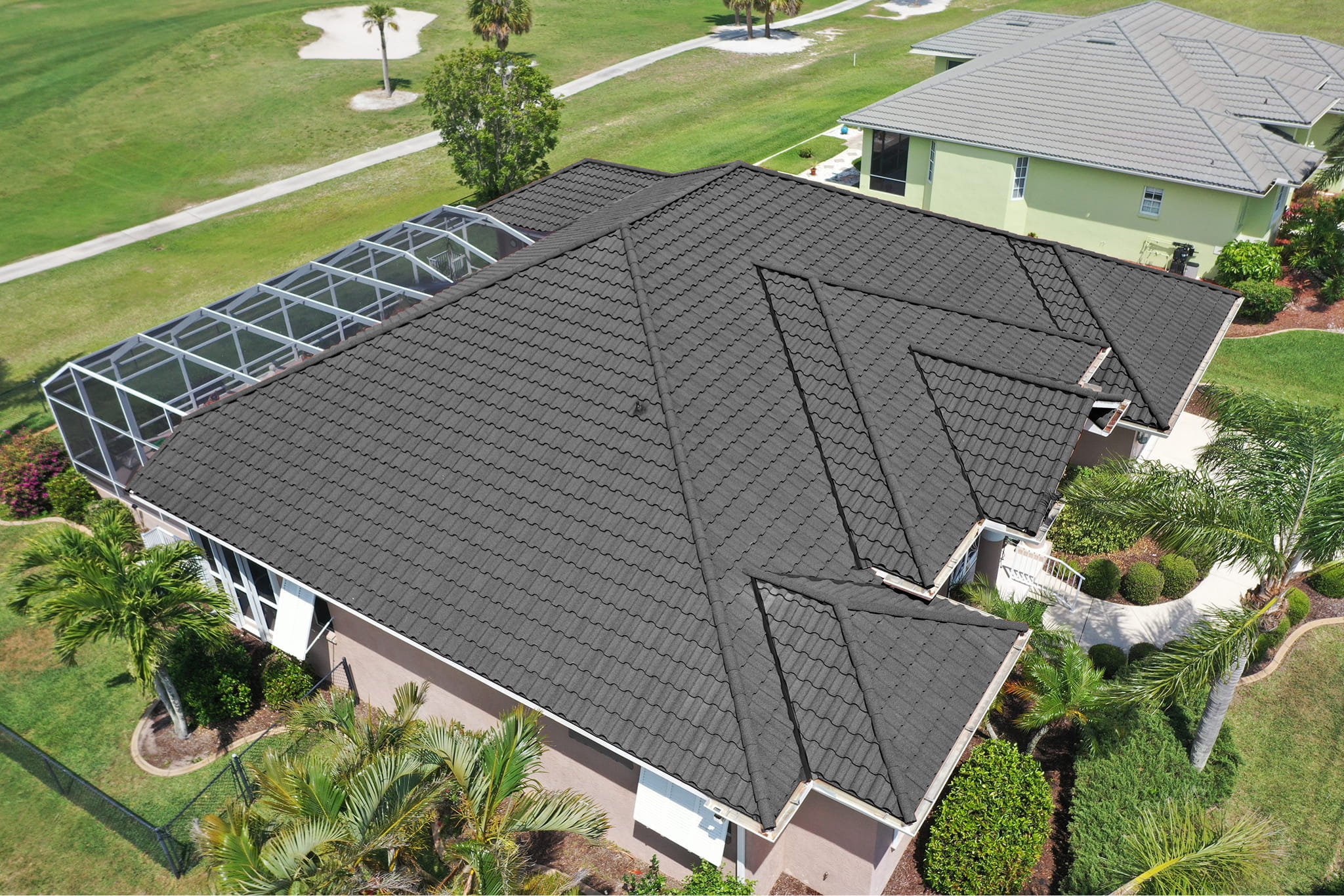 Aerial view of DECRA Spanish Tile Cathedral Stone premium stone-coated steel roof on a Florida home overlooking a golf course