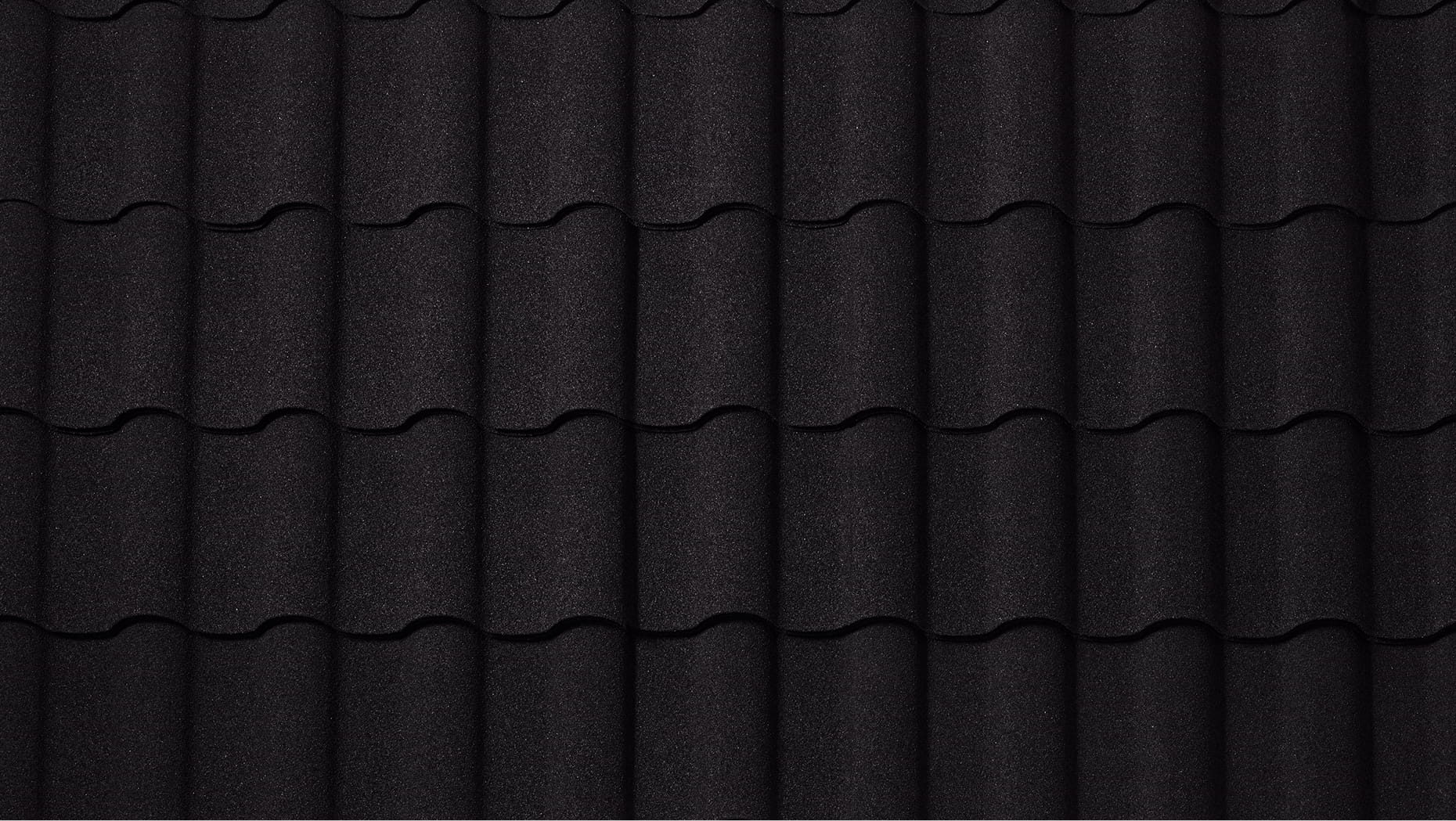 DECRA Spanish-style barrel tile in Carbon finish showing textured stone-granule metal roofing tiles for premium roof design