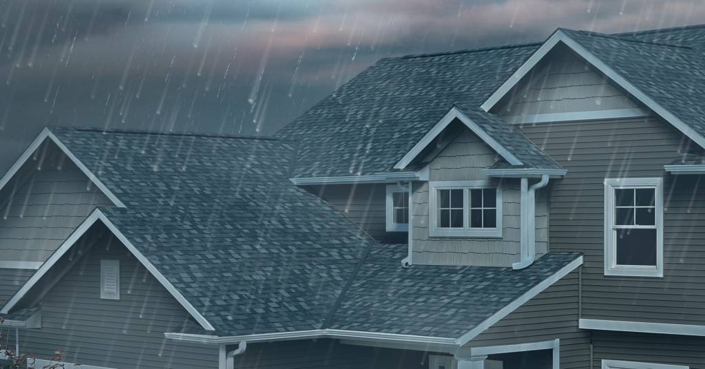 A house with a grey roof in the middle of a hail storm.