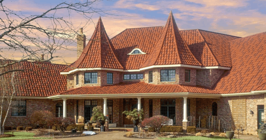 Spanish-Style Barrel Tile on a luxury brick house highlighting stone-coated steel barrel tiles and Mediterranean curves