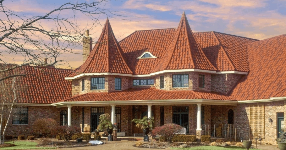 Spanish-Style Barrel Tile on a luxury brick house highlighting stone-coated steel barrel tiles and Mediterranean curves