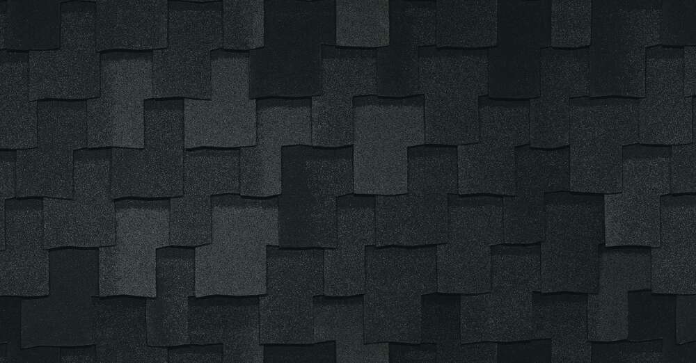 Primer plano de tejas Armourshake en capas en Shadow Black, que muestran un patrón texturizado y superpuesto.
