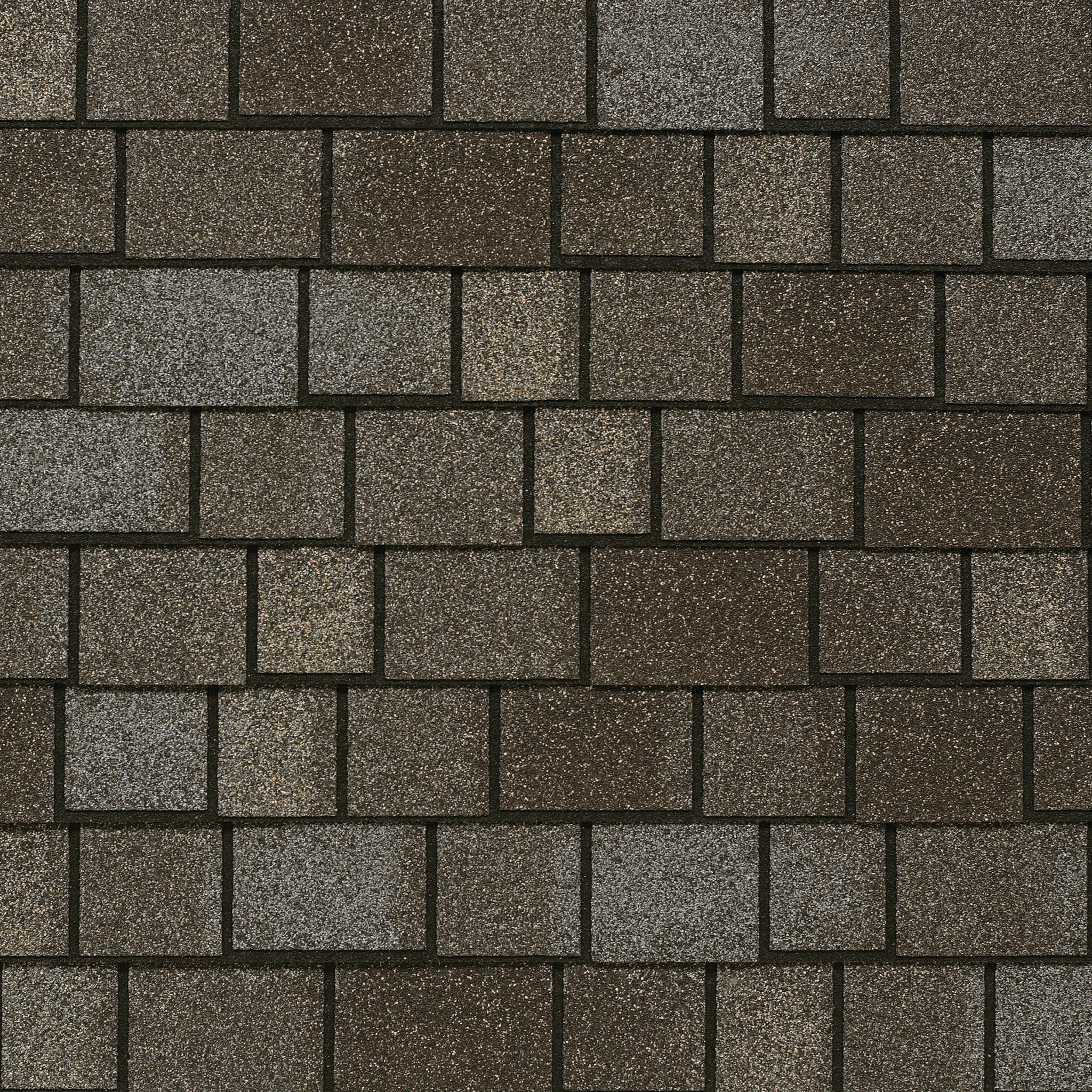 Close-up view of a roof featuring Royal Estate asphalt shingles in a rectangular pattern, with an elegant blend of grey and brown hues.