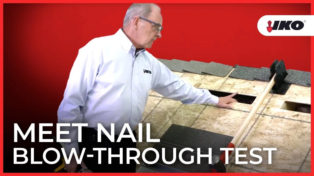 A man demonstrating the nail blow-through test on a roofing board, expertly showing different nail placements while highlighting the durability of IKO ArmourZone shingles.