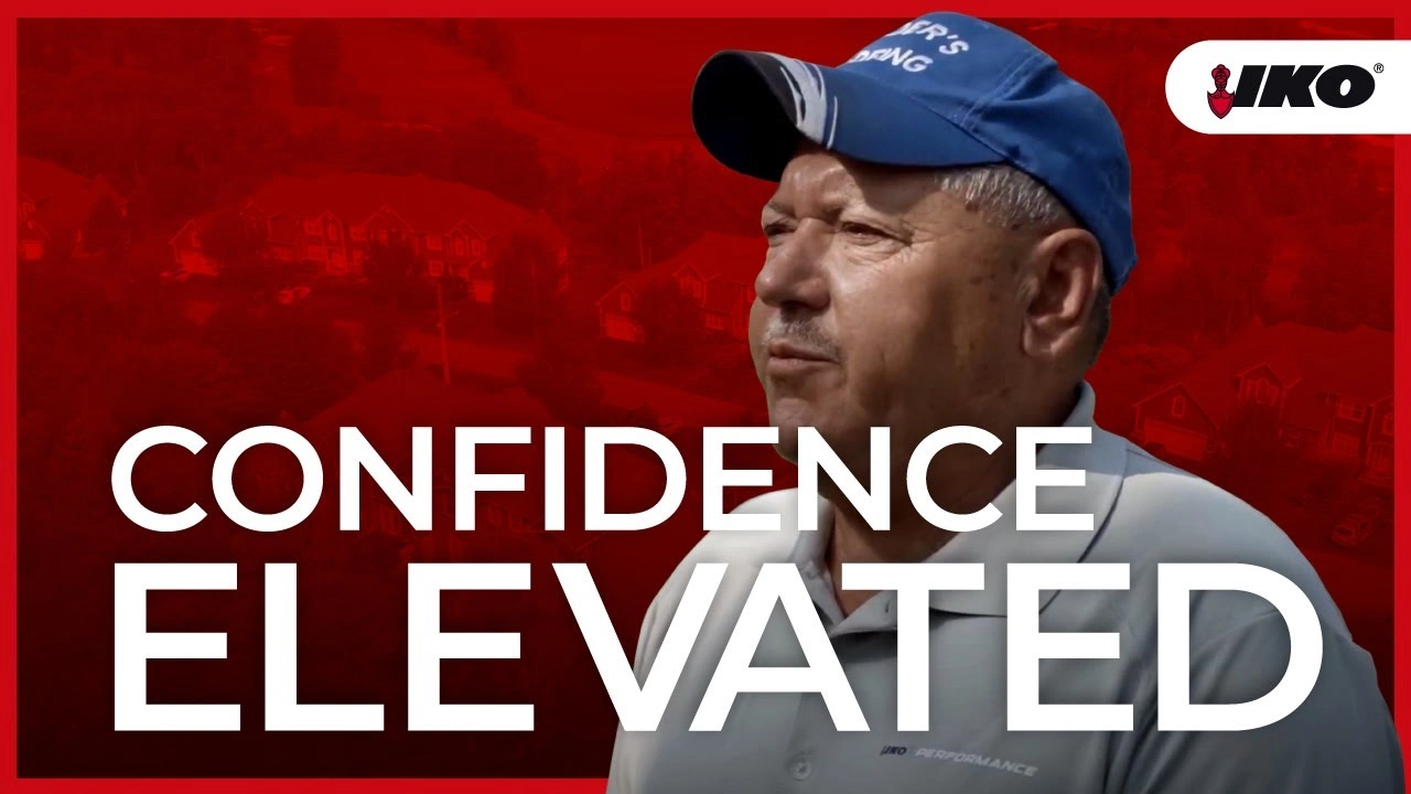 Man in a blue cap and polo shirt stands confidently in front of a red background with "Confidence Elevated" text, embodying the trusted expertise of Mader's Roofing.