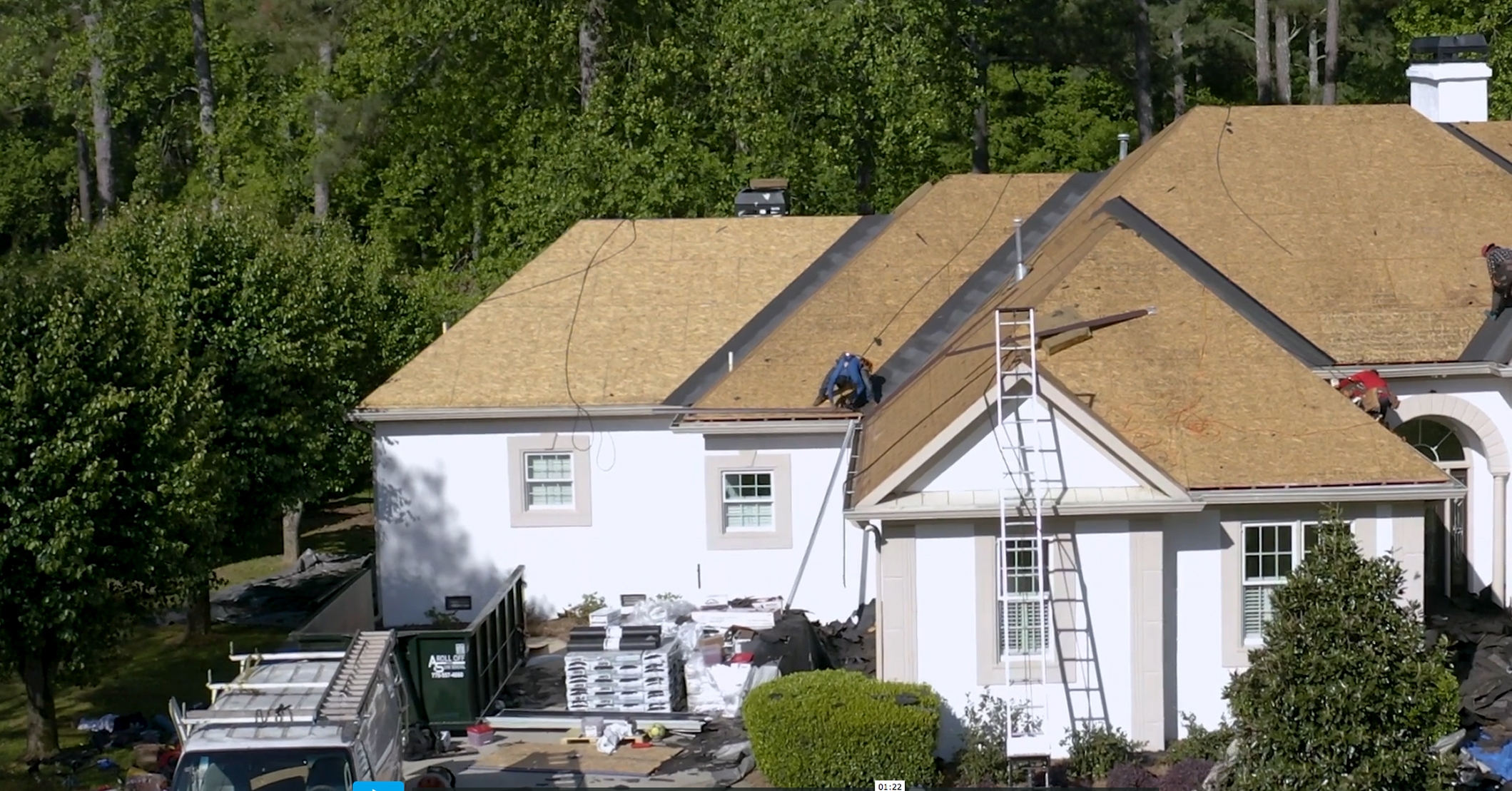 Large residential roof being prepped for shingles with underlayment, tools, and materials on-site.