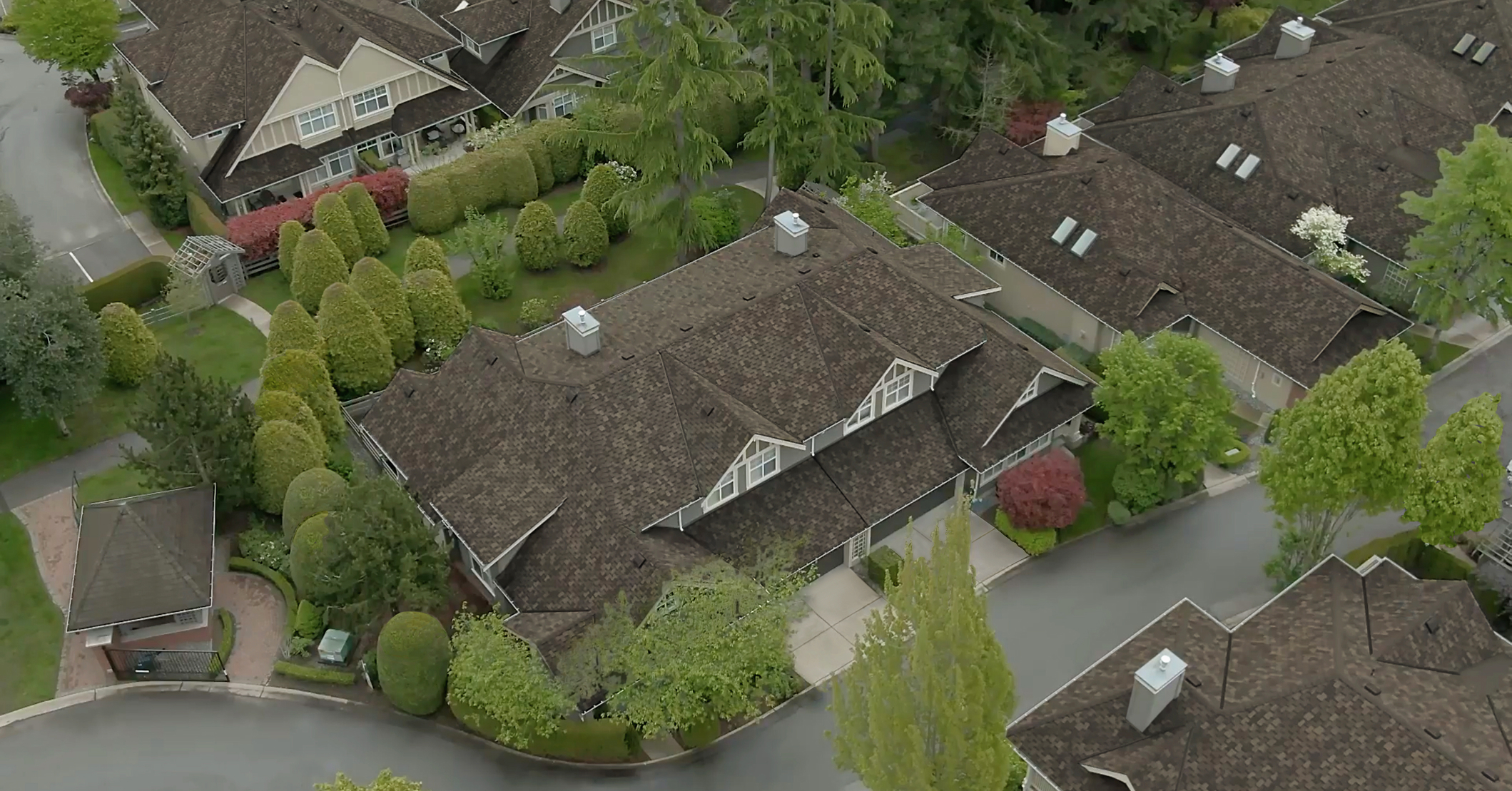 Bird’s eye view of brown shingle roofs.