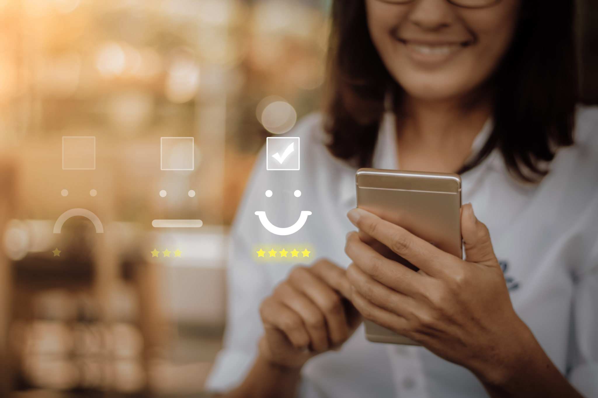 Smiling woman holds a smartphone with a five-star happy face rating shown in front of her.