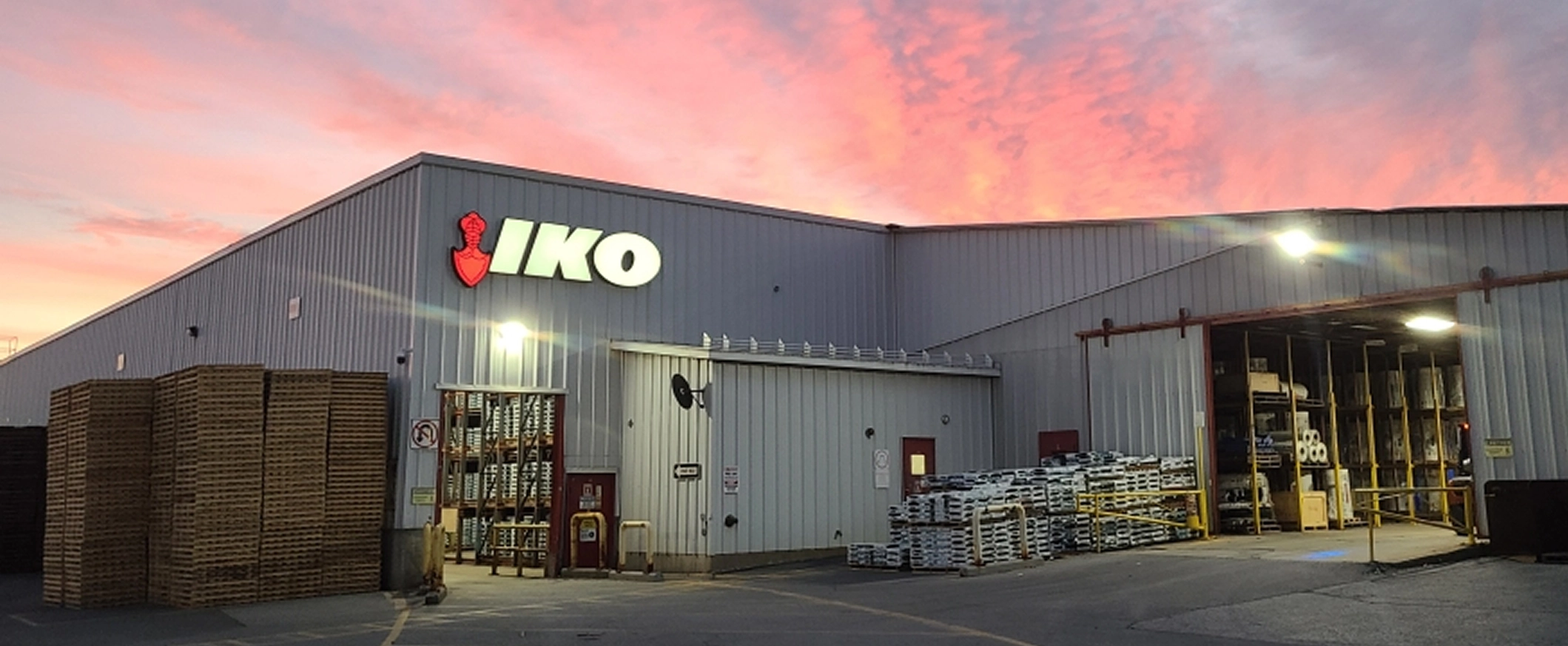 Exterior view of an IKO manufacturing facility at sunset