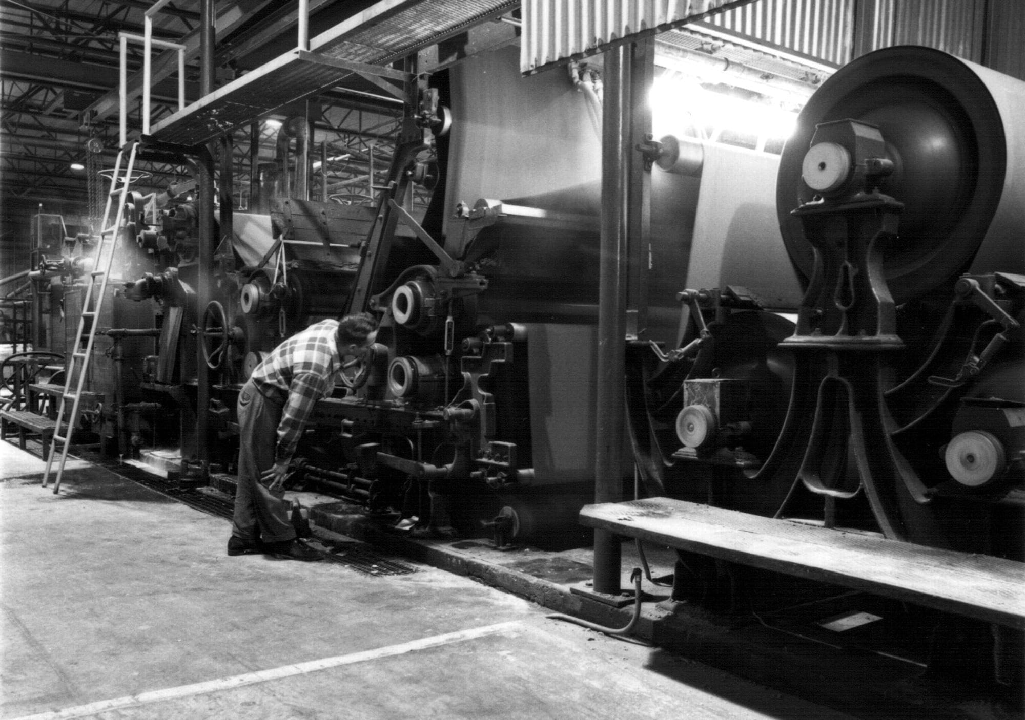 vintage photo of a man in a circa 1960 paper-making factory