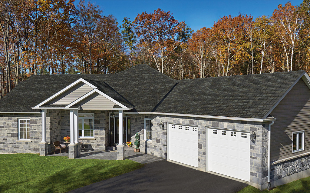 House with an IKO Royal Estate Mountain Slate shingle roof, stone accents and a two-car garage