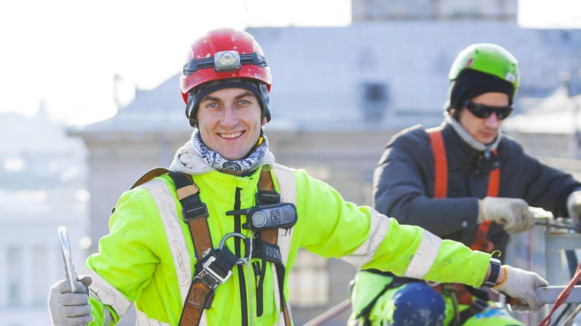 worker wearing safety body harness and hard hat