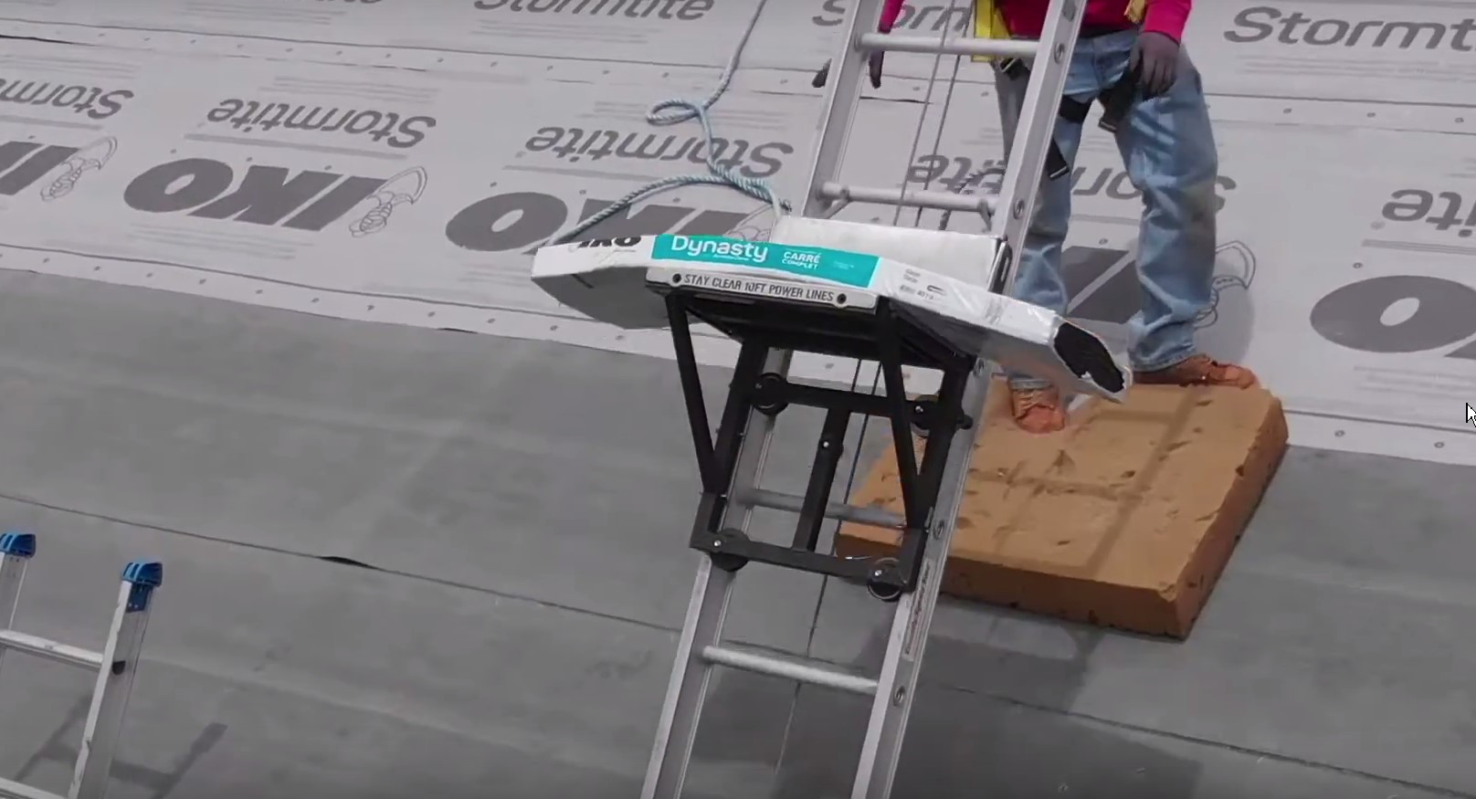 bundle of shingles lifted to rooftop