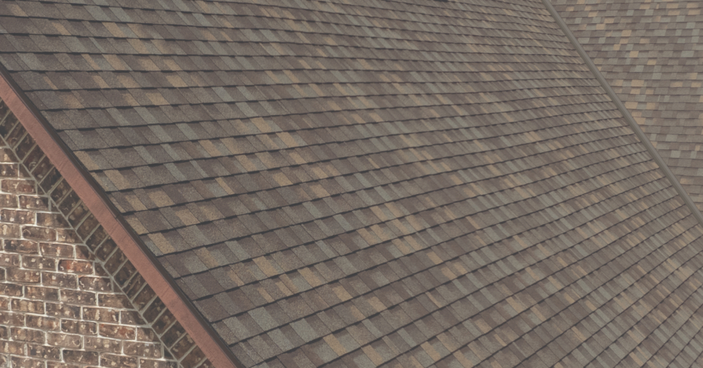 A brick home with dark brown IKO shingles on the roof.