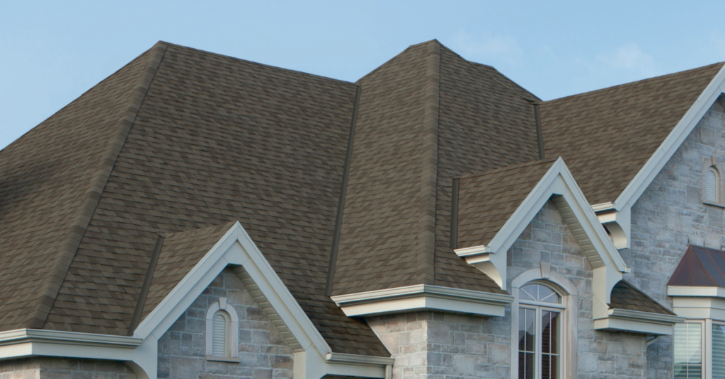 A home with a stone facade with dark brown IKO shingles on the roof.
