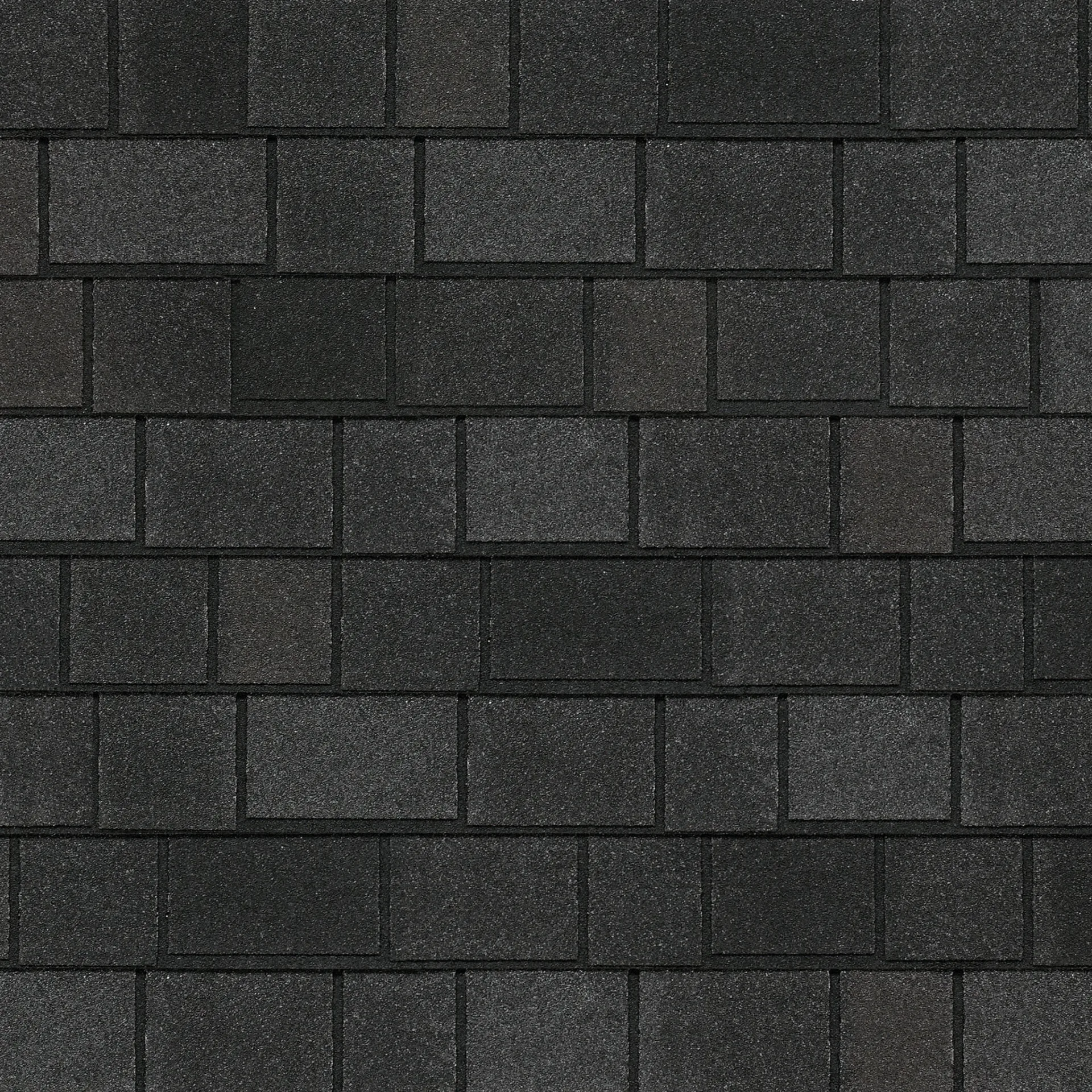 Primer plano de un techo de tejas de asfalto que muestra el diseño elegante de Royal Estate, con tejas rectangulares texturizadas de color gris oscuro en patrón escalonado que recuerdan a Shadow Slate.
