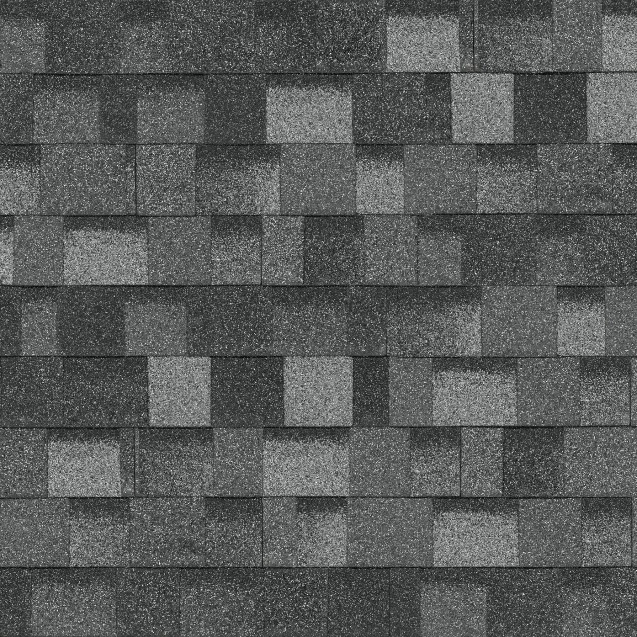 A close-up view of a roof covered with Summit Grey asphalt shingles, arranged in a Nordic-inspired staggered pattern.