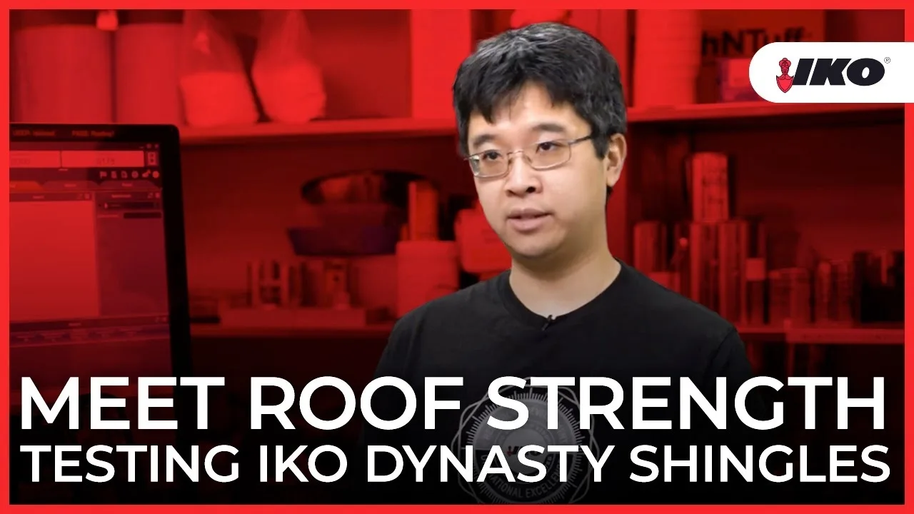 A person stands before a computer screen, overlaying promotional text about the rigorous testing of IKO Dynasty Shingles to ensure exceptional roof strength.