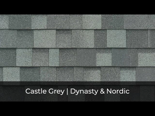 Close-up of a textured, grey shingle roof pattern labeled "Castle Grey," showcasing the exquisite craftsmanship and durability attributed to the Dynasty & Nordic collections.