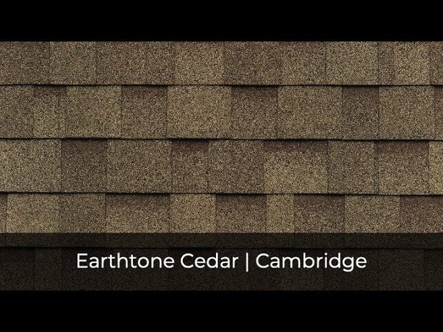 Close-up of Cambridge Earthtone Cedar roof shingles by IKO. The textured, layered pattern highlights the rich hues in the shingle colors beautifully.
