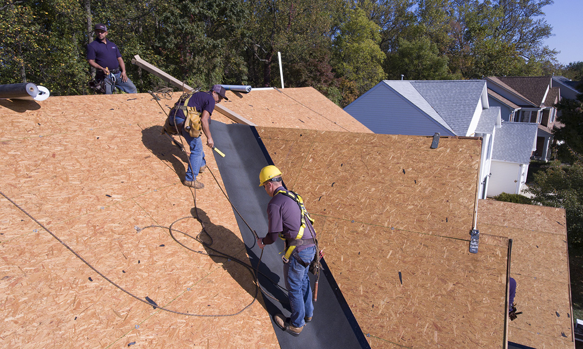roofers installing valley flashing membrane