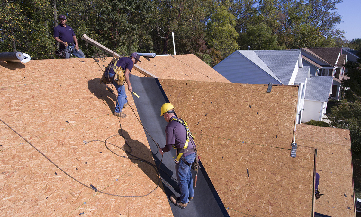 roofers intalling ice and water protector in a valley