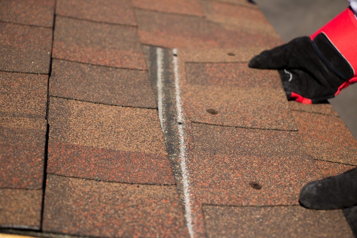 shingle being removed from roof