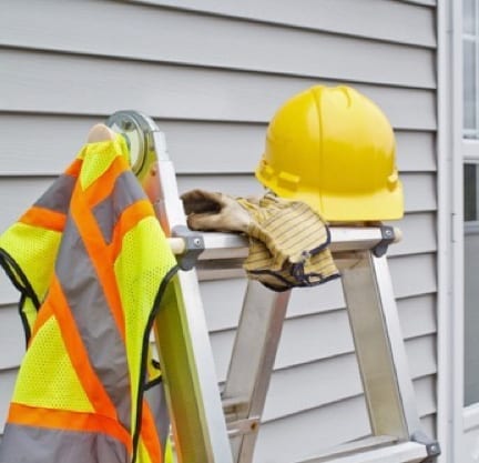 rooofer's safety equipment resting on ladder