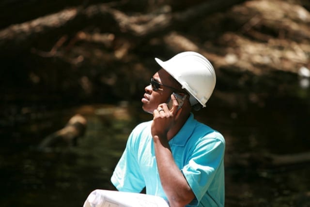 Roofing contractor on the phone with a homeowner.