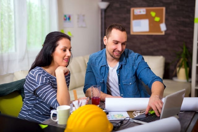 Set client expectations from the start. Photo of client and contractor together, examining project plans