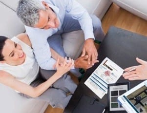 couple in the home discussing a roofing job with roofer 